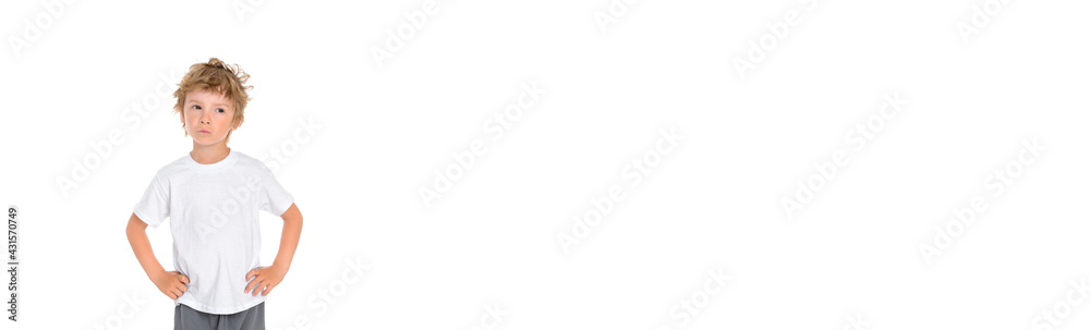 Handsome little boy expresses dissatisfaction with his posture and facial expression. Studio portrait on white isolated background. Banner with free copy space Handsome little boy expresses dissatisfaction with his posture and facial expression. Studio portrait on white isolated background. Banner with free copy space