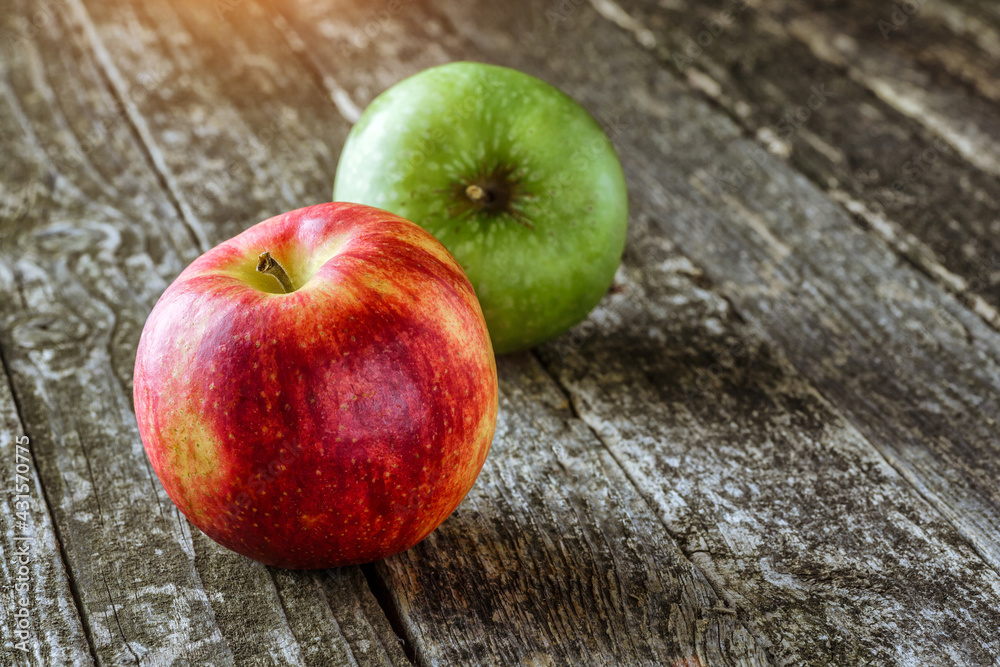 Green and red apples on blackboard or chalkboard background. Bright fruit composition.Red and green apple on old wooden table. Top view with space for your text Green and red apples on blackboard or chalkboard background. Bright fruit composition.Red and green apple on old wooden table. Top view with space for your text