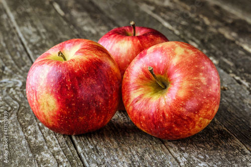 Green and red apples on blackboard or chalkboard background. Bright fruit composition.Red and green apple on old wooden table. Top view with space for your text