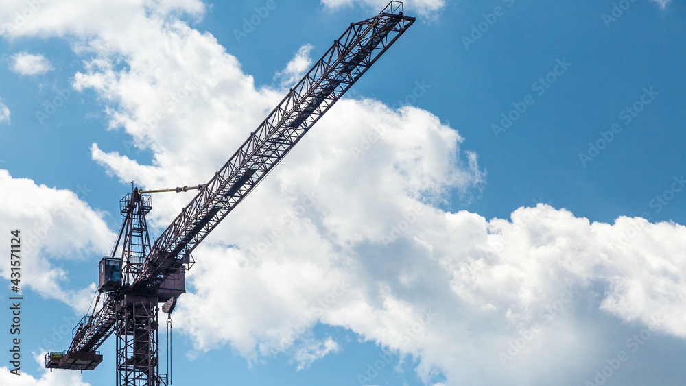 Abstract Industrial background with construction cranes silhouettes over amazing sunset sky.Building construction site work against blue sky