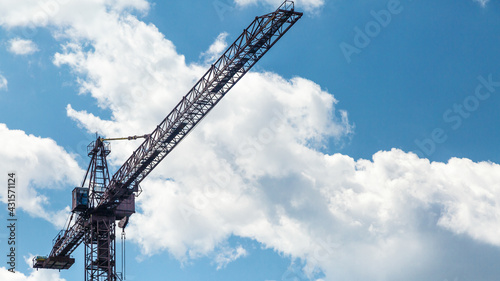 Abstract Industrial background with construction cranes silhouettes over amazing sunset sky.Building construction site work against blue sky