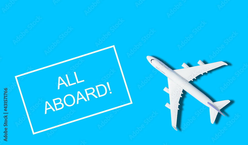 Flat lay design of travel concept with plane on blue background with copy space
