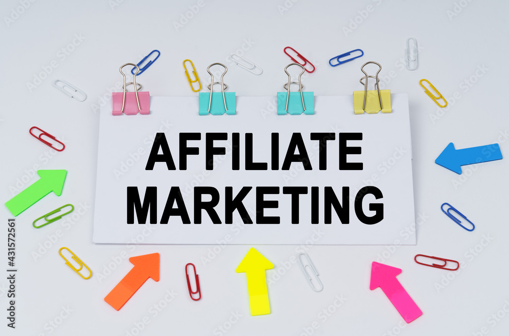 On the table there are paper clips and directional arrows, a sign that says - AFFILIATE MARKETING On the table there are paper clips and directional arrows, a sign that says - AFFILIATE MARKETING