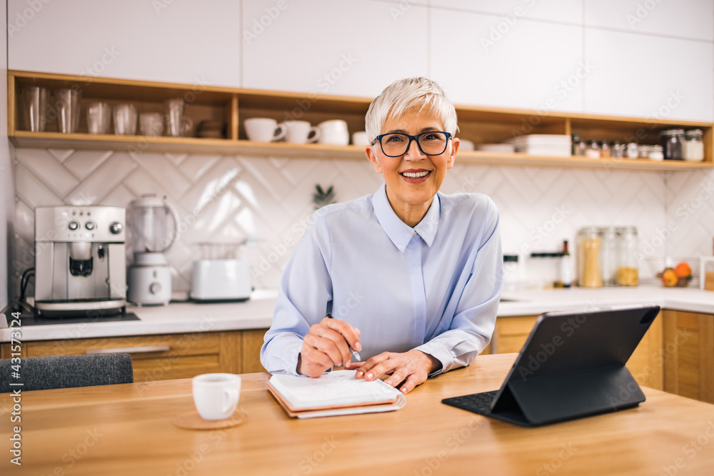 Portrait of a smiling senior businesswoman at home. Working from home. Portrait of a smiling senior businesswoman at home. Working from home.