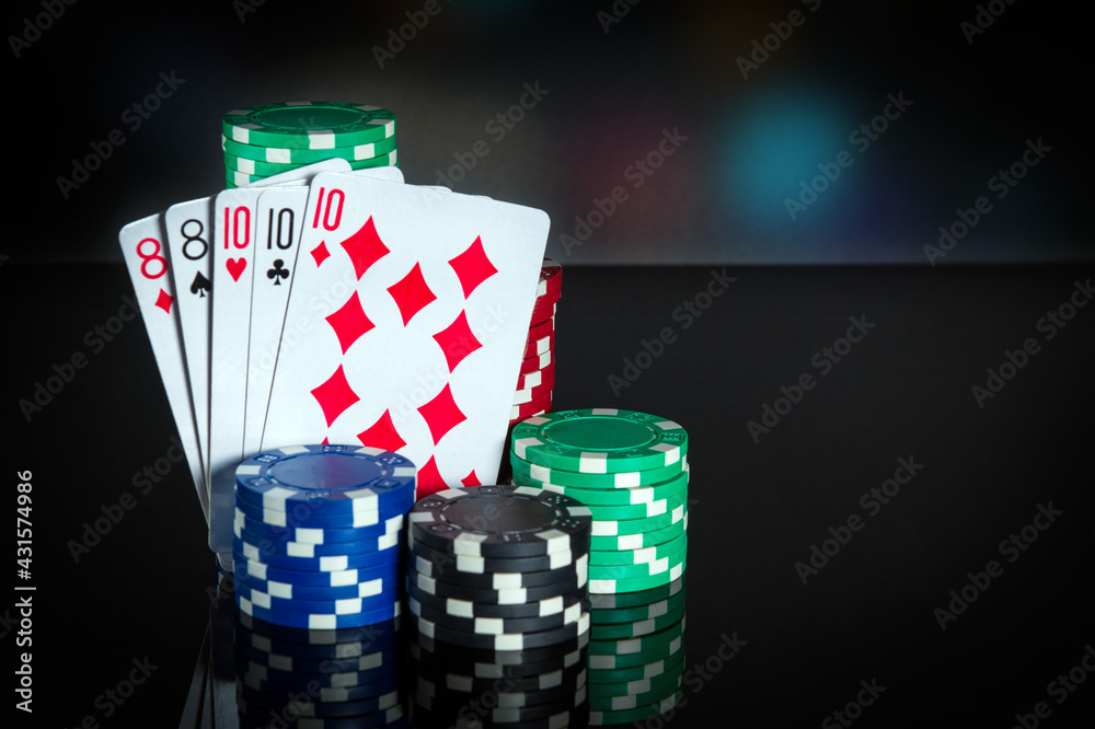 Obraz premium Poker cards with full house or full boat combination. Close-up of playing cards and chips in poker club. Free advertising space