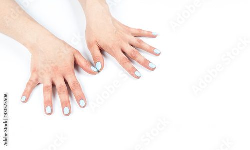 Manicure. Female hands with turquoise manicure. On white background.