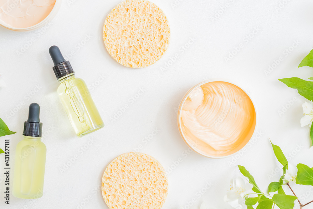 Flat lay composition with cosmetics and jasmine flowers on a light background - obrazy, fototapety, plakaty 