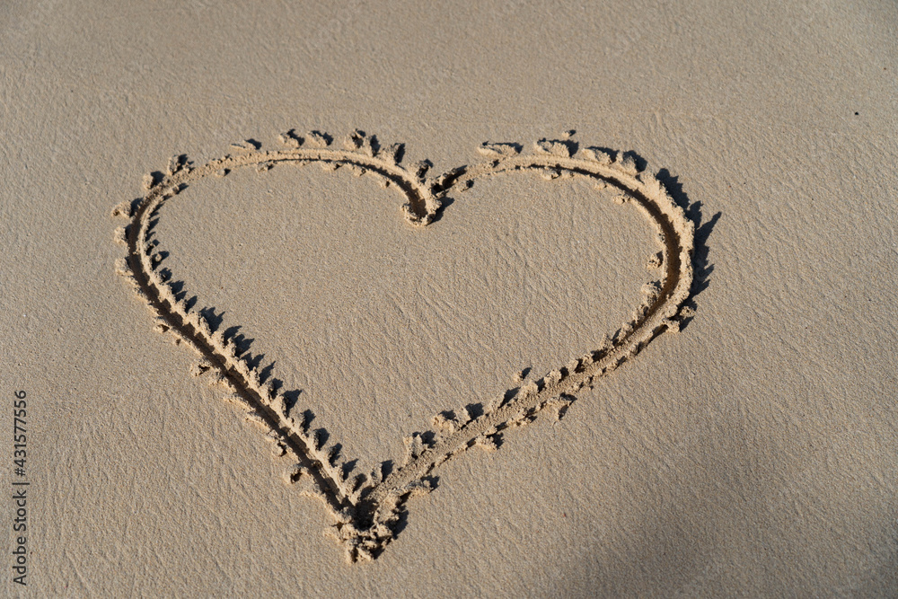 drawing of Hart in the sand, the symbol for love. Concept of relationship and togetherness