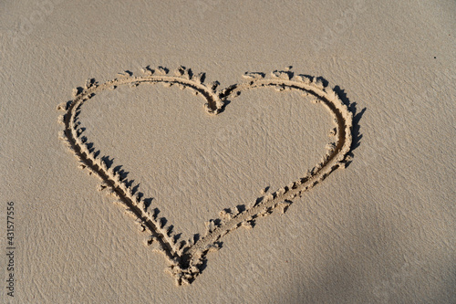drawing of Hart in the sand, the symbol for love. Concept of relationship and togetherness