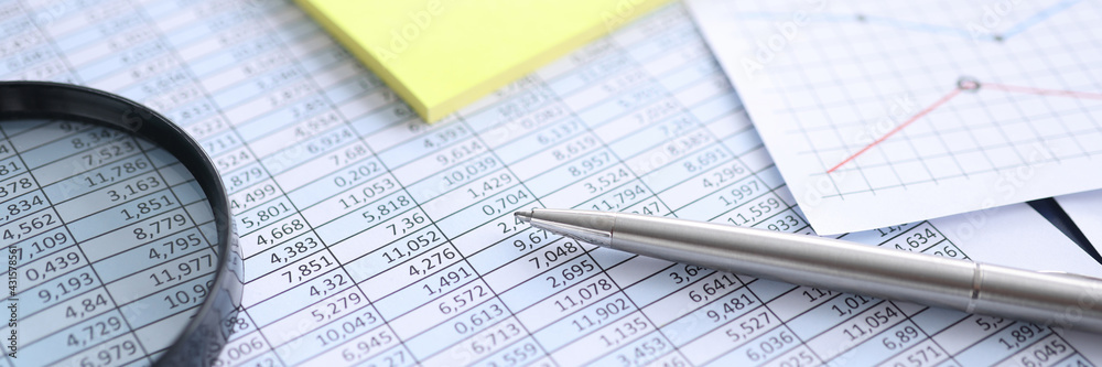 Papers with digital indicators magnifier and pen Papers with digital indicators magnifier and pen