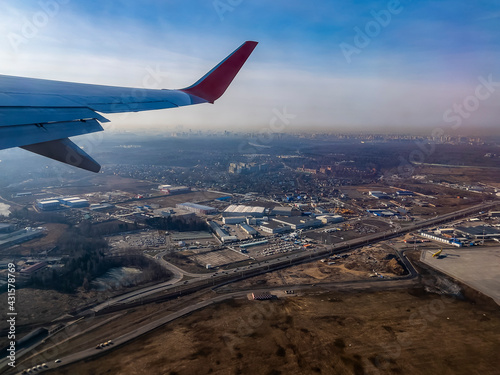 View of the land surface from a window of the plane flying at big height, Moscow region