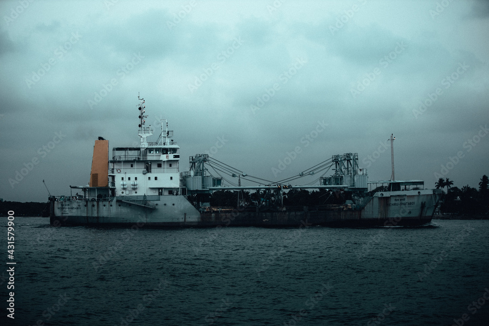 photograph of ship in the port taken from my camera in a moody day in kerala, India.
