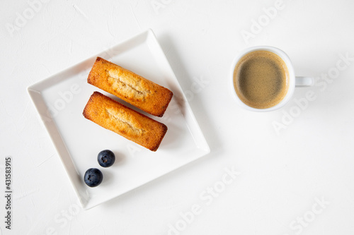 Bilde på lerret Traditional French dessert - financier cake pastries with blueberry on a white p