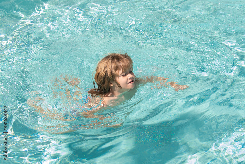 Happy child in pool. Pool resort. Summer weekend. Smilling boy at aquapark. Kid swimming in water.