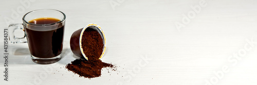 Espresso coffee on white background with open capsule. Outdoor format.