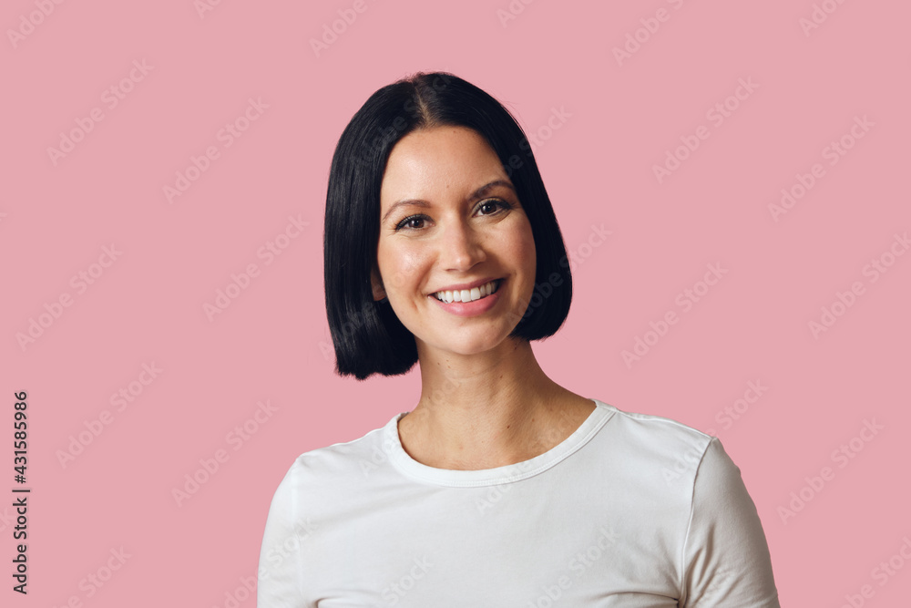 Studio portrait of brunette smiling looking at camera Studio portrait of brunette smiling looking at camera