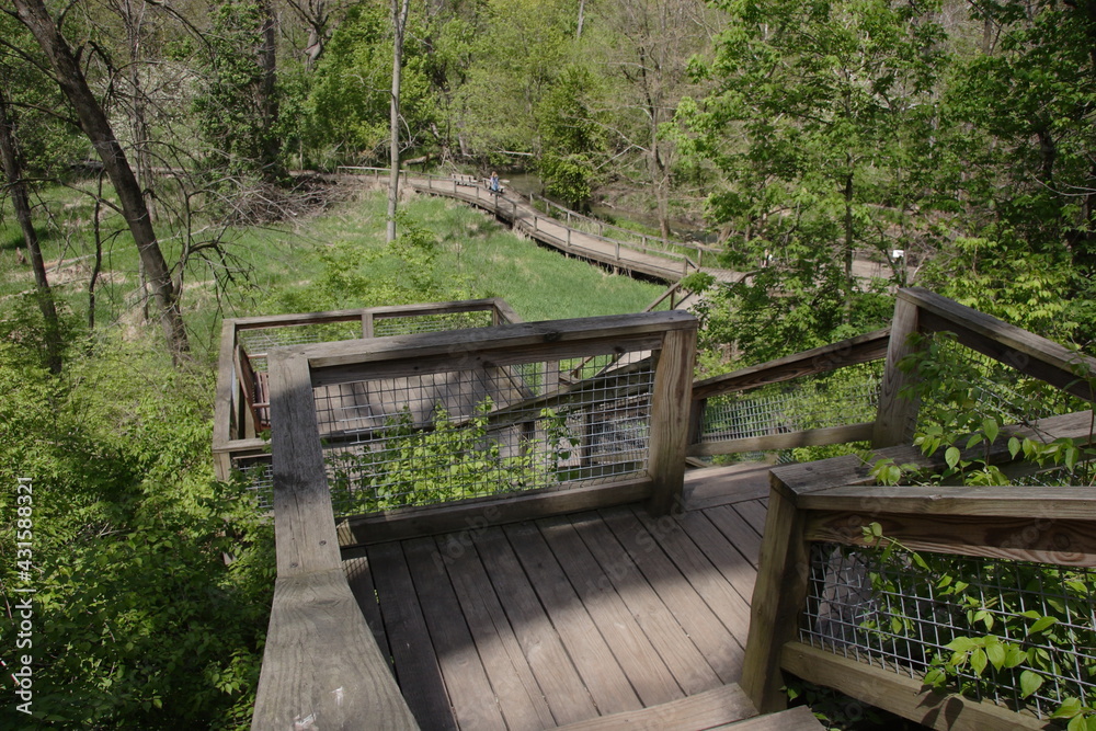 Wooden staircases leading down to a riverside boardwalk