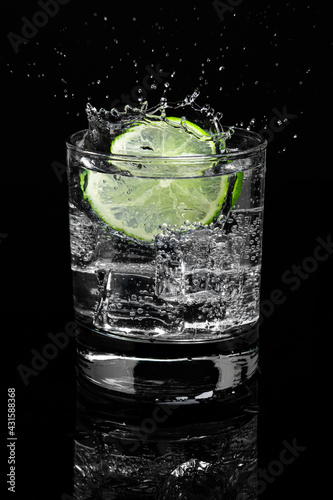 Mojito Lime Water with Splash highball glass gin and tonic on dark background. Food menu restaurant.