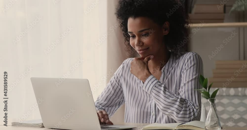 Young African businesswoman working on project typing on computer, writes answer to client remotely, search information, freelancer thinking over creative telecommute, workday at home office concept Young African businesswoman working on project typing on computer, writes answer to client remotely, search information, freelancer thinking over creative telecommute, workday at home office concept