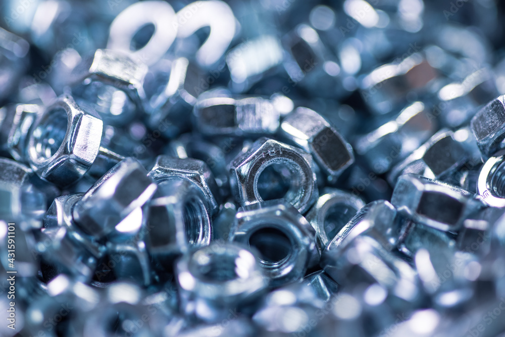 Metal chrome nuts in a chaotic order industrial background Metal chrome nuts in a chaotic order industrial background