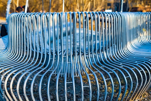Close-up street bench metal pipes arranged parallel