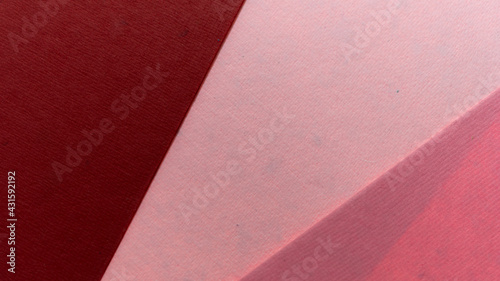 overlapping deep red light and medium pink textured paper 