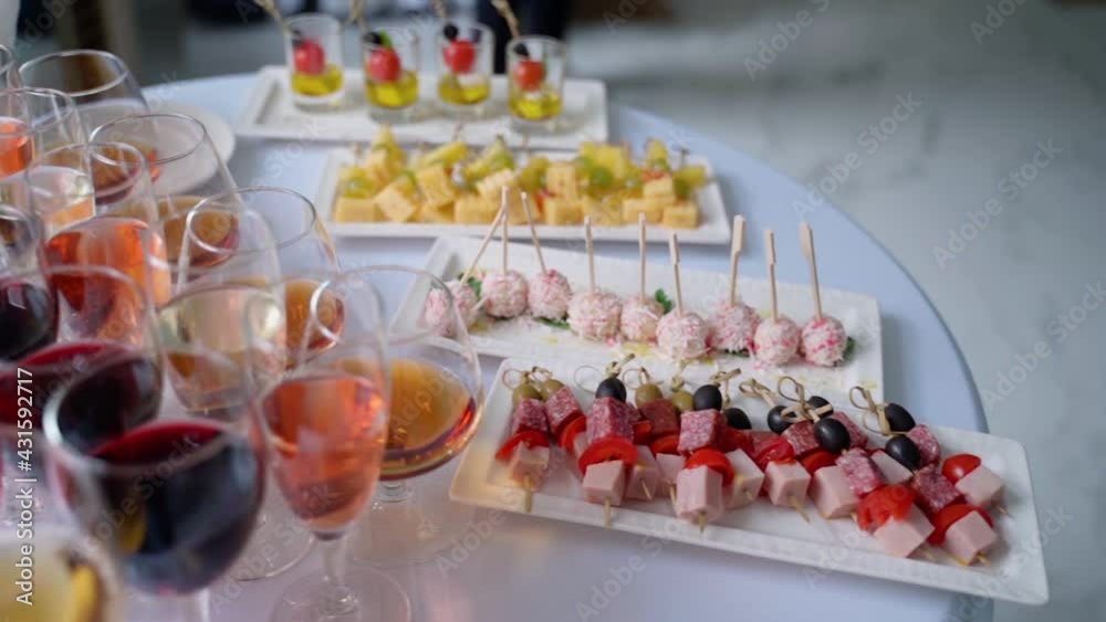 Buffet at the reception. Assortment of canapes. Banquet service. Catering food, snacks with cheese, meat and tomatoes Buffet at the reception. Assortment of canapes. Banquet service. Catering food, snacks with cheese, meat and tomatoes