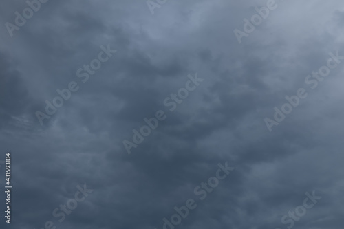 Evening dark blue rainy sky with clouds. Cloudy weather with overhanging rain. Heavy clouds