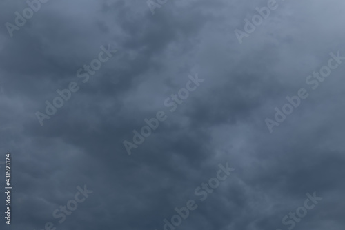 Evening dark blue rainy sky with clouds. Cloudy weather with overhanging rain. Heavy clouds