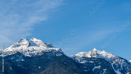 Beautiful snow-capped Columbia Mountains against the blue sky in British Columbia Canada
