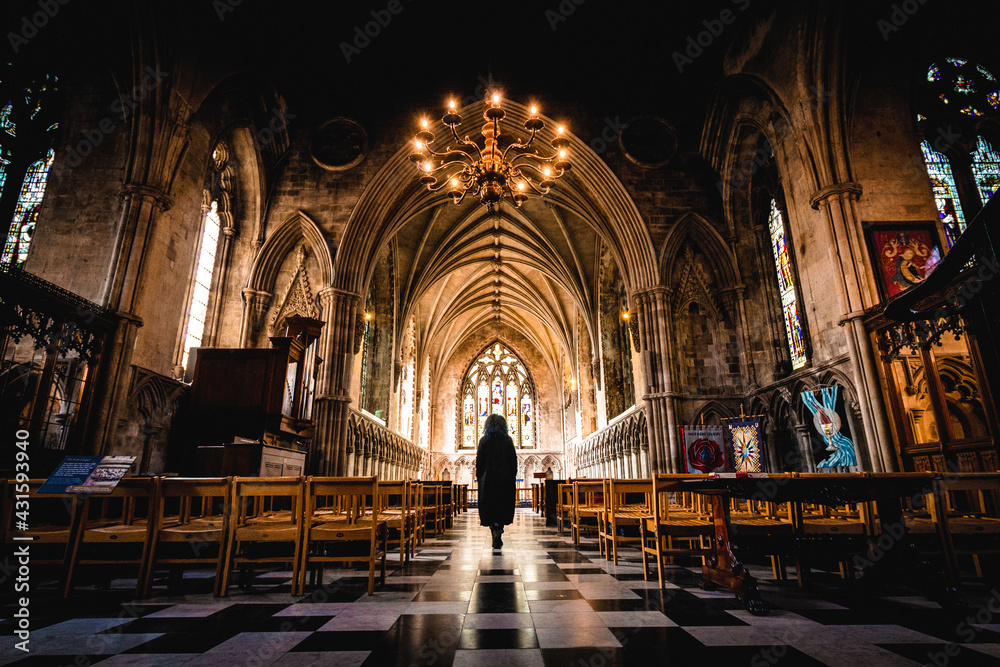 Atmospheric gothic silhouette walking in church