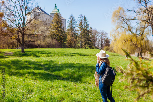 Tourist walking in Olesko Castle garden. Ancient architecture landmarks in Western Ukraine. Traveling