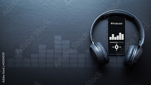 Podcast background. Mobile smartphone screen with podcast application, sound headphones. Audio voice with radio microphone on black. Recording studio or podcasting banner with copy space. photo