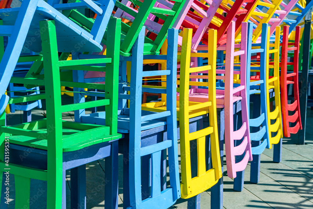 Colored chairs composed in non-working period, a street outdoor cafe in the Turkish city of Kas