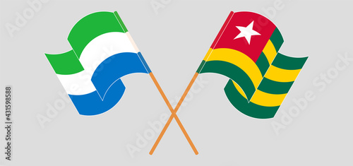 Crossed and waving flags of Sierra Leone and Togo