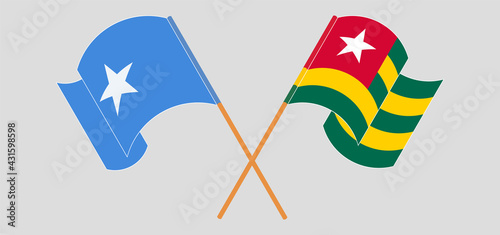 Crossed and waving flags of Somalia and Togo