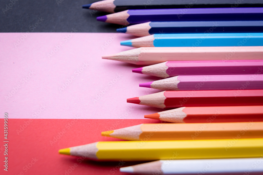 Fototapeta premium Colorful pencil set on pink, red background