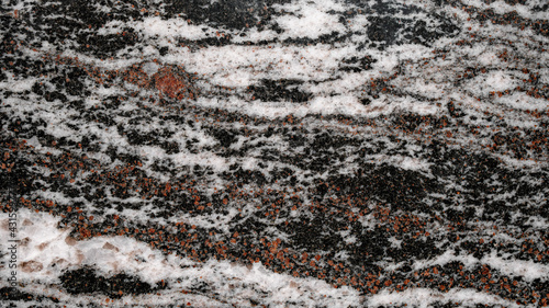 Mineral natural stone polished close-up surface texture. Black, white with red spots. © Maxim Kukurund