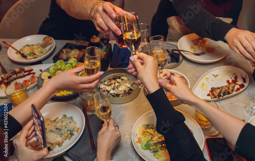 Clinking glasses with alcohol and toasting, party.
