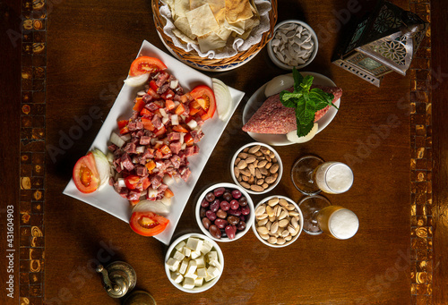 Traditional Middle Eastern food. Lebanese food. Arabian raw meat salad, berr glass, kibbeh, tomatoes, top view
