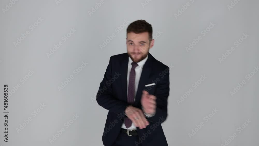 Young handsome businessman in suit dancing than going still Young handsome businessman in suit dancing than going still