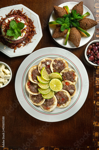 Traditional Middle Eastern food. Lebanese Sfiha meat. Arabian sfeeha plate. Esfiha with lemons. Kibbeh Kibe. Top View
