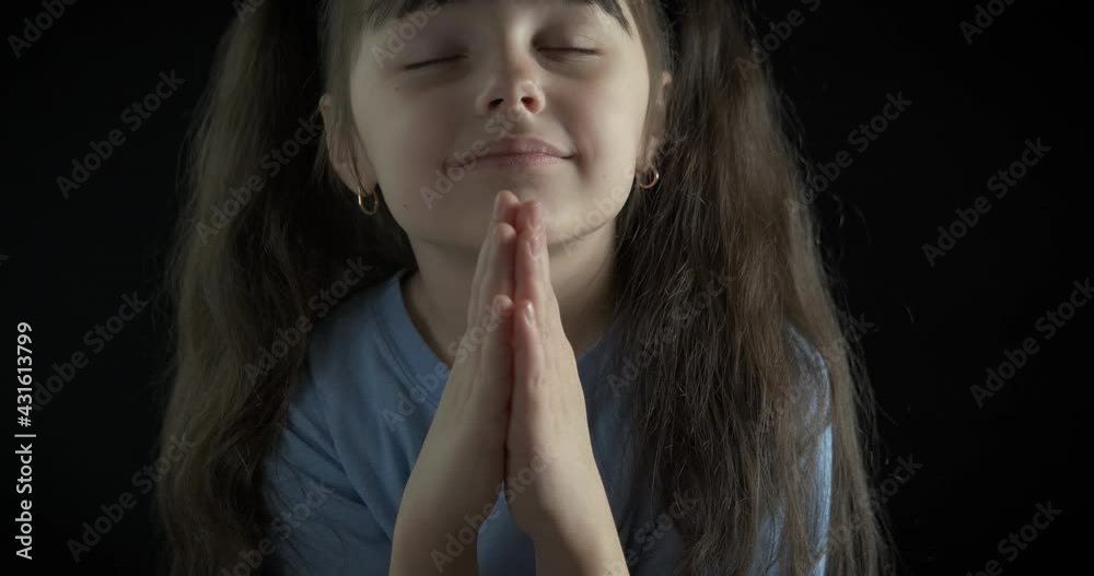 Portrait of a praying little girl.