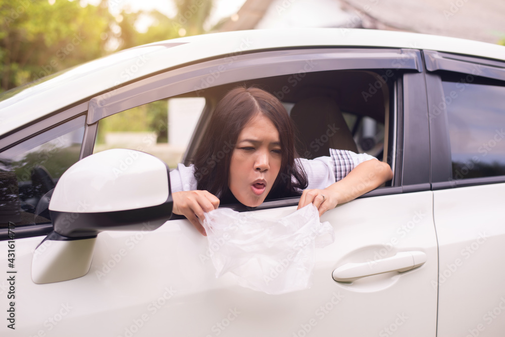 Asian woman puke or vomiting into plastic bag in car,Car Sick and