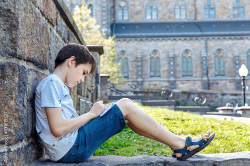 Принти на полотні Boy writing outside. School study concept
