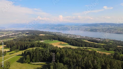 Aerial drone shot above Pfannenstiel flying towards lake Zürich in Switzerland photo