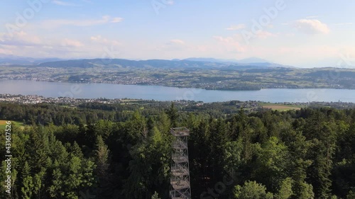 Aerial drone shot rotating around Pfannenstiel observation tower revealing lake Zürich in the background photo