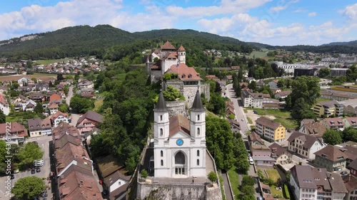 Aerial drone shot flying up and above the church and fortress in the town of Aarburg in Switezrland while tilting down photo