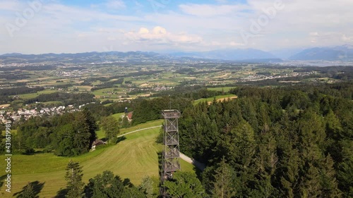 Aerial drone shot flying around the Pfannenstiel observation tower in the canton of Zürich, Switzerland with the countyside in the background photo