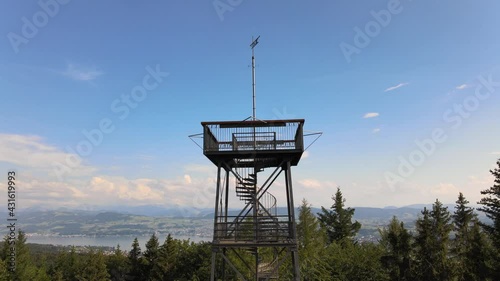 Aerial close drone shot flying up and tilting down showing the Pfannenstiel observation tower in the canton of Zürich, Switzerland revealing the lake in the background photo